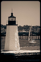 Sailboat Approaches Newport Harbor Light in Busy Harbor